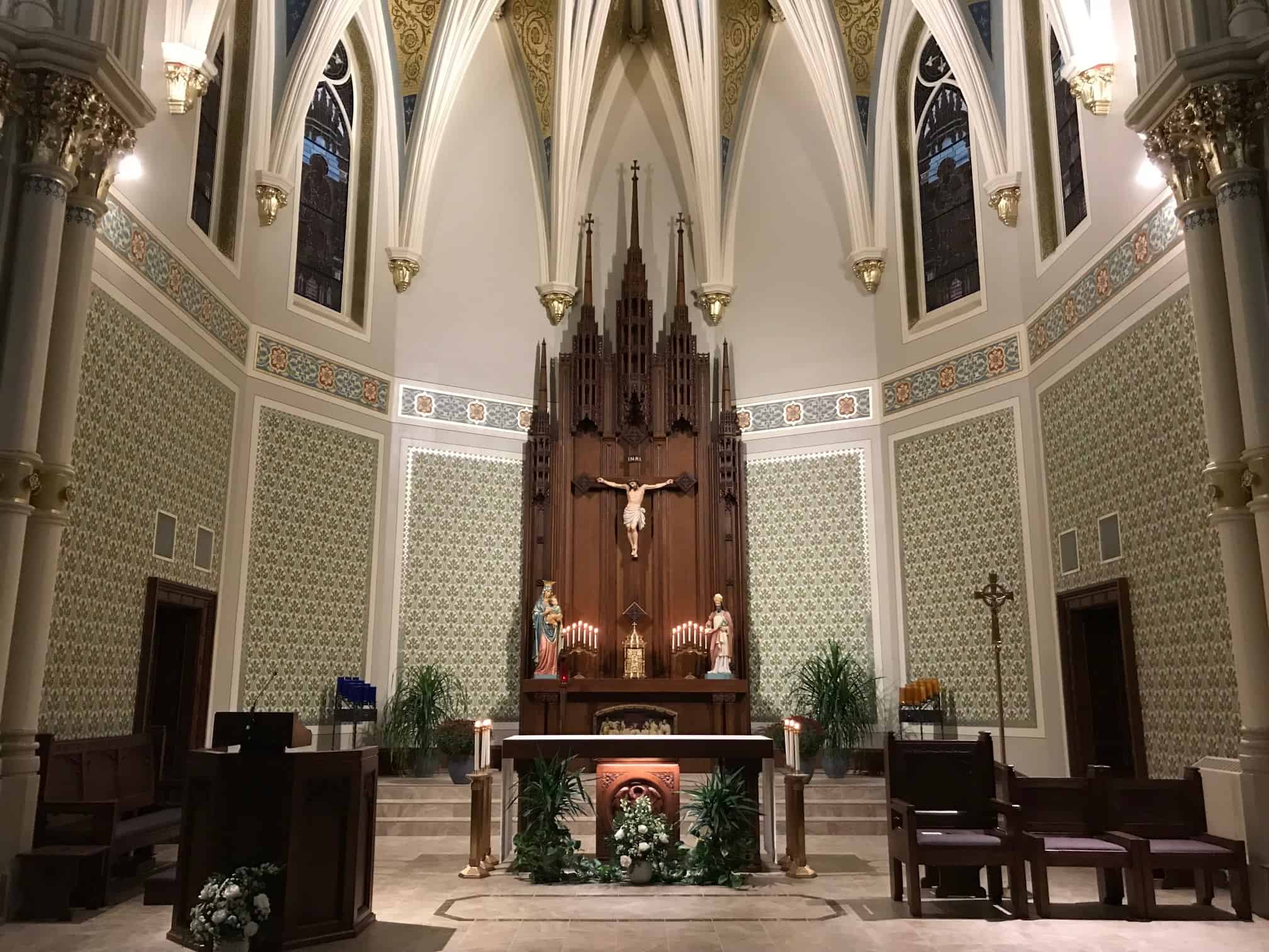 sanctuary and altar with tabernacle and candles in front of crucifix